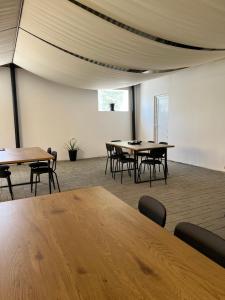 a room with tables and chairs and a ceiling at Maison 25 in 2 Mai