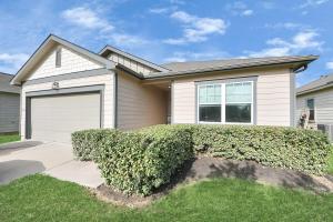 a house with a bush in front of it at Family-Friendly 4 Bed & 2 Bath Oasis with Fully Equipped Kitchen & Relaxing Vibes in Brookshire