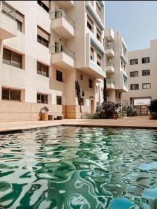 a swimming pool in front of a building at Appartement avec piscine in Essaouira