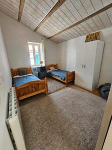 a large room with two beds and a window at Maison Rétaise près de la Plage in Saint-Clément-des-Baleines