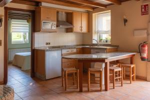 a kitchen with a table and chairs and a sink at Casa LarSanAdrian 2 in Verdes