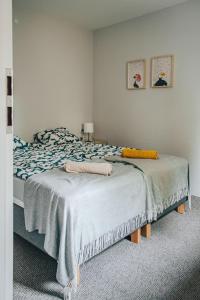 a bedroom with a bed with two pillows on it at Kalma Roztocze in Tereszpol Zaorenda