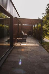 a pavilion with a picnic table and benches on a patio at Kalma Roztocze in Tereszpol Zaorenda