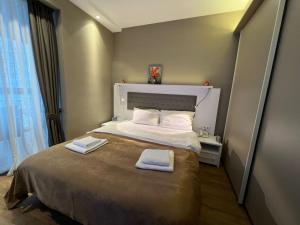 a bedroom with a bed with two towels on it at alliance panorama Batumi in Batumi