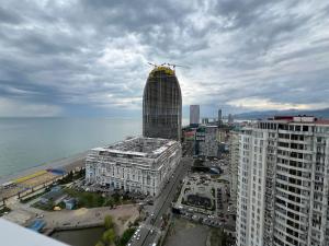 a tall building with a crane on top of it at alliance panorama Batumi in Batumi