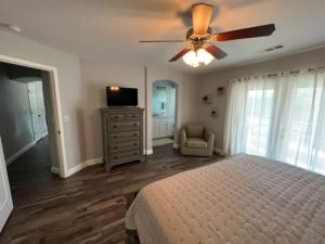 a bedroom with a bed and a ceiling fan at Cadbury 4BR Outdoor Kitchen Sleeps 8 Peaceful in Bakersfield