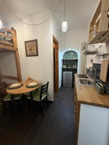 a kitchen with a table and a kitchen with a sink at Casa Carmela Cerasuolo Filignano in Filignano +4 photos