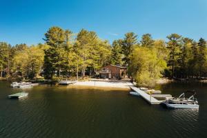 a group of boats are docked on a lake at Scenic Spider Lake Beach Resort Pontoon Rentals in Traverse City