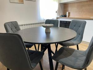a dining room table with chairs and a table and a table and chairsktop at Studio apartman SALOPEK 2 in Ogulin +3 photos