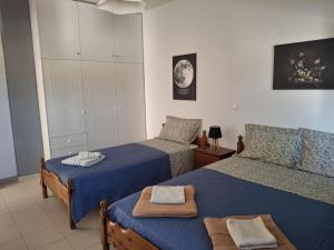 a bedroom with two beds with towels on them at Angel's apartments in Panayía