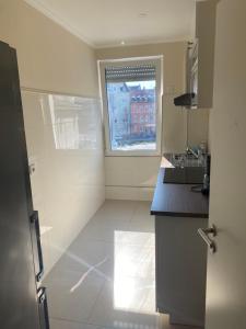 a kitchen with a sink and a window in it at InterAssist 2 in Heidelberg +8 photos