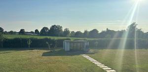 a small box sitting in the middle of a field at Little George in Rayne