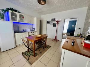 a kitchen with a table and a refrigerator at Royal Casino Namur Balcony in Namur