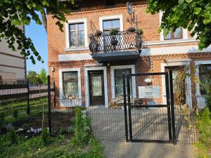 a gate in front of a brick building at Magical places Unter den Linden in Reszel