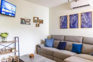 a living room with a couch and a tv at Cozy Condo with Panoramic Hillside Views from Rooftop Terrace and Short Walk to Beach in Coco +42 photos