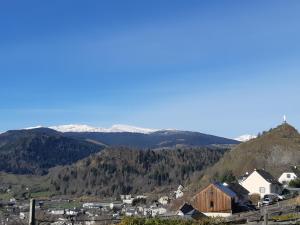 a small town with snow capped mountains in the background at LeVolduMilan in Murat