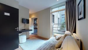 a living room with a couch and a window at Villa Sablon in Brussels