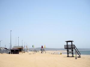 a beach with two play structures on the sand at Beach Front Villa in Souira Guedima +13 photos