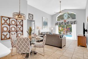 a living room with a couch and a table at Allamanda at White Rose Villas in Kissimmee