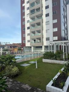 a view of a building with a garden and a building at Apartamento bem localizado perto de tudo - 3 quartos em Belém in Belém