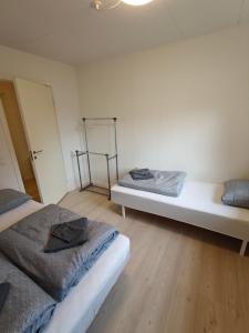 two beds sitting in a room with wooden floors at Capital of LEGO Bricks - Room 06 in Billund +7 photos