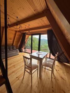 a dining room with a table and two chairs at Bali Glamping in Ambrolauri