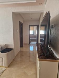 a living room with a flat screen tv on a counter at الشروق 2 résidence chourouk 2 in Mansouria