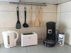 a kitchen counter with utensils and a coffee maker at le studio du lac in Annecy