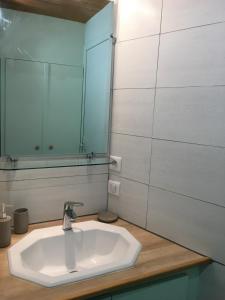 a bathroom with a white sink and a mirror at le studio du lac in Annecy