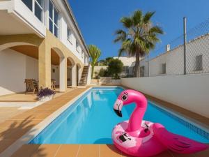 a pink flamingo float in a swimming pool at Charming Catalan Villa with Pool & Views in Cunit