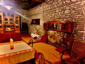 a room with a bed and a stone wall at Dzveli Galavani -Old Wall in Telavi
