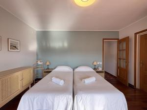 a room with two beds with white sheets at Charming Catalan Villa with Pool & Views in Cunit