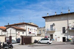 a white car parked in a parking lot next to buildings at Casa Vacanza Diadema in Matera