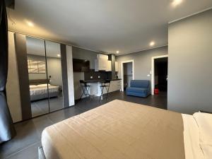 a bedroom with a bed and a kitchen and a room at ANGELICA Luxury in Bologna