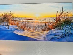 a painting of a beach with the sun setting over the water at Hotel-Style, No Host, Professionally Managed ID252 in Jersey City