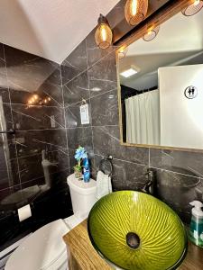 a bathroom with a green sink and a tub at Hotel-Style, No Host, Professionally Managed ID252 in Jersey City