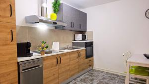 a kitchen with wooden cabinets and stainless steel appliances at Propiedad San Salvador in Mogán