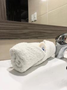 a towel sitting on top of a bathroom sink at MOKA HOUSE in Santo Domingo +146 photos