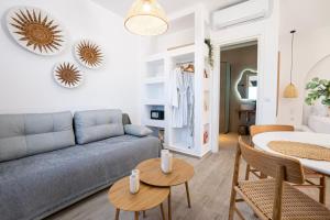 a living room with a couch and a table at Majestic View Villa - Outdoor Jacuzzi in Arkasa