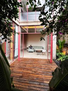 a person sitting on a couch in the middle of a building at Xolo Condesa in Mexico City