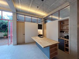 a kitchen with a wooden counter in a room at Xolo Condesa in Mexico City