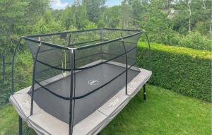 a batting cage sitting on the grass at 4 Bedroom Awesome Home In Sandefjord in Sandefjord +20 photos