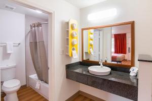 a bathroom with a sink and a toilet and a mirror at Motel 6-Grand Prairie, TX - Near Six Flags Drive in Grand Prairie