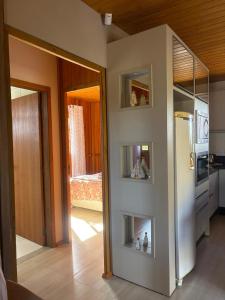 a room with a kitchen with a refrigerator in it at Casa de Campo in Barracão +10 photos