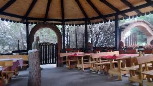 a gazebo with tables and chairs in at Mića Alas vikendica in Orljane