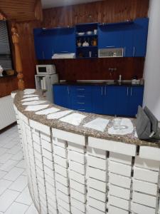 a kitchen with blue cabinets and a counter top at Mića Alas vikendica in Orljane +5 photos