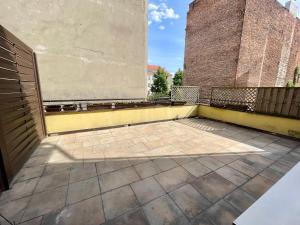a balcony of a building with a brick wall at Apartament Lipowa in Kalisz