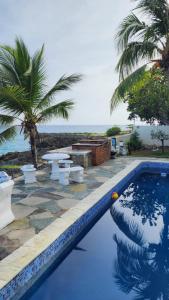 a swimming pool with a view of the ocean at Crimson beach ocean front entire floor villa in Sosúa