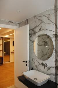 a bathroom with a sink and a mirror at Vironas Hotel in Himare