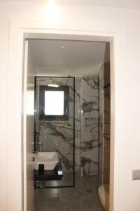 a bathroom with a sink and a mirror at Vironas Hotel in Himare